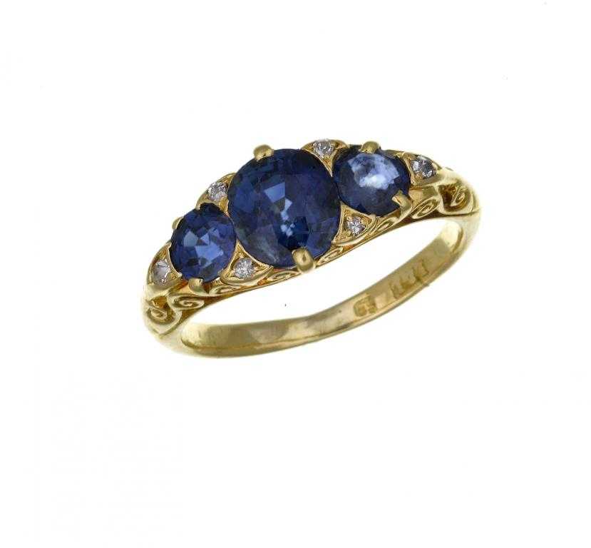 Appraisal: A SAPPHIRE THREE STONE RING with rose diamond accents ct