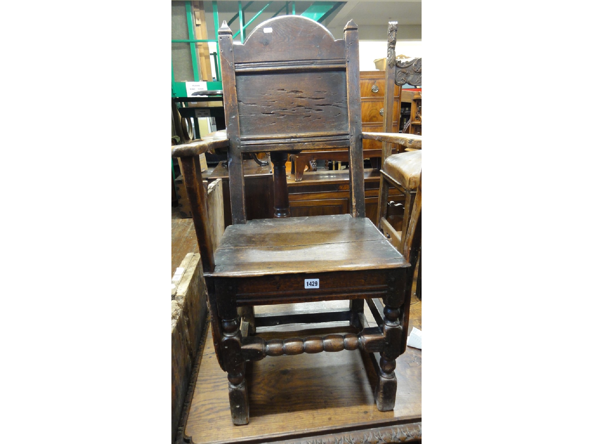 Appraisal: An th century country made oak elbow chair with simple