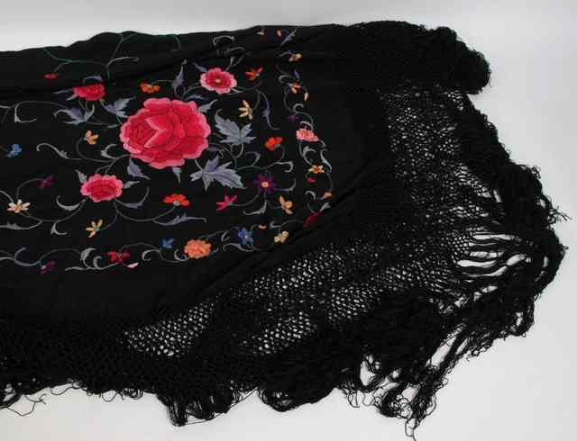 Appraisal: A Spanish black silk shawl embroidered polychrome flowers with black