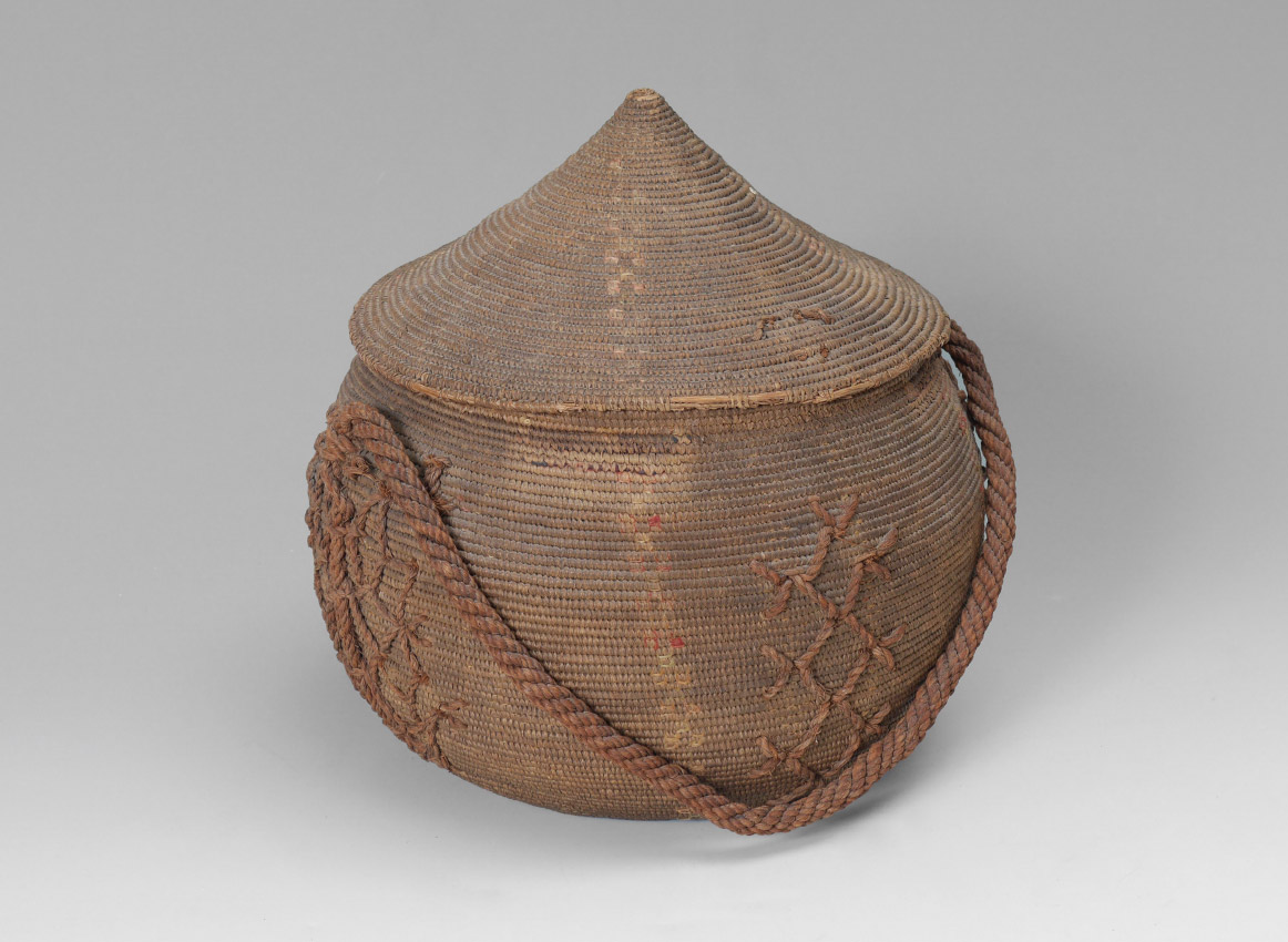 Appraisal: AFRICAN WOVEN COVERED BASKET With woven decoration and handle Overall