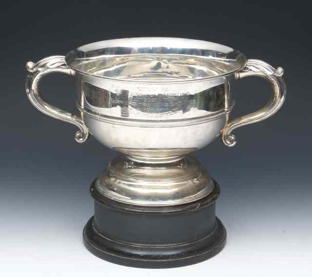 Appraisal: A TWO HANDLED SILVER TROPHY CUP with turned stepped foot