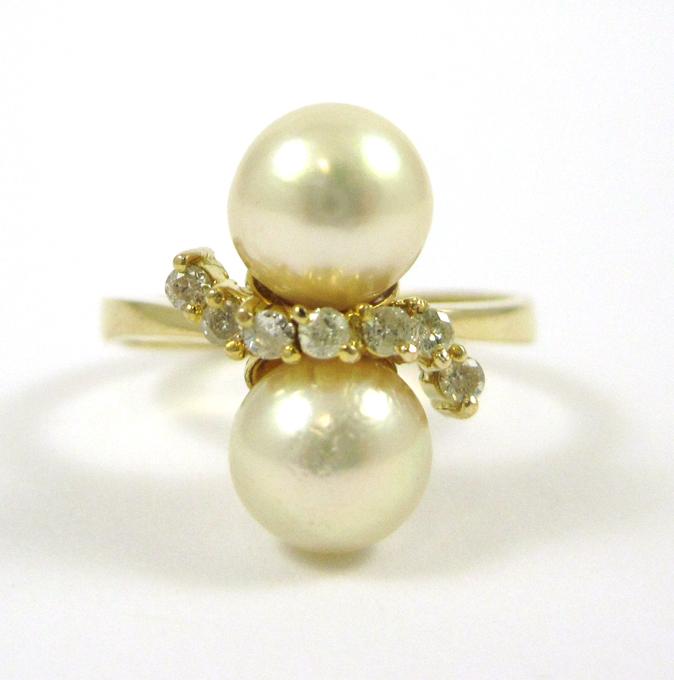 Appraisal: PEARL DIAMOND AND FOURTEEN KARAT GOLD RING set with two