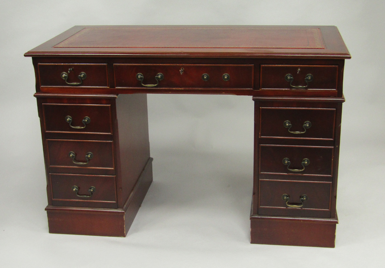 Appraisal: A mahogany twin pedestal desk tooled red leather over one