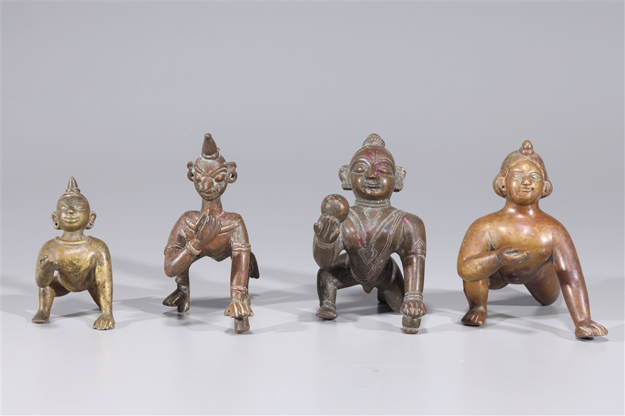 Appraisal: Group of four antique Indian Bala Krishna statues with incised