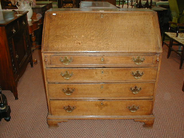 Appraisal: A George III oak bureau fall flap revealing a fitted