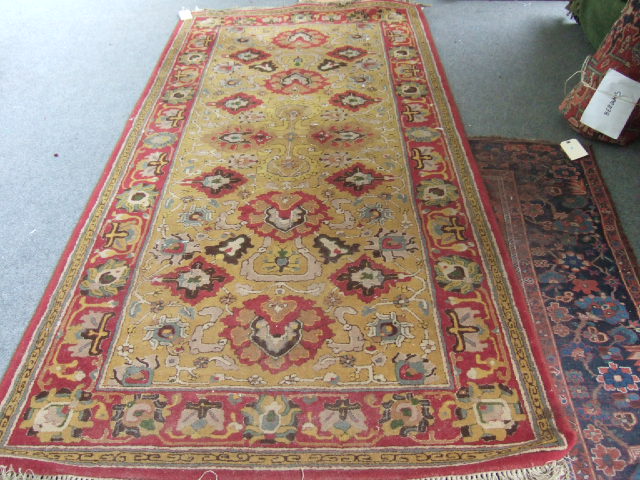 Appraisal: A Chinese machine made rug a saffron field with palmettes