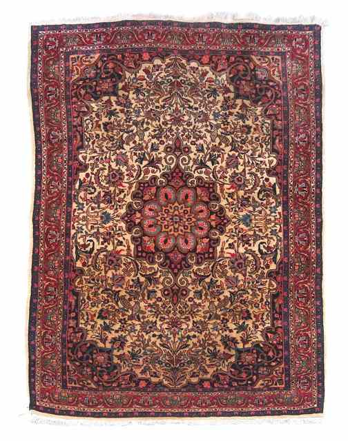 Appraisal: A SAROUK FAWN GROUND RUG with a central foliate medallion