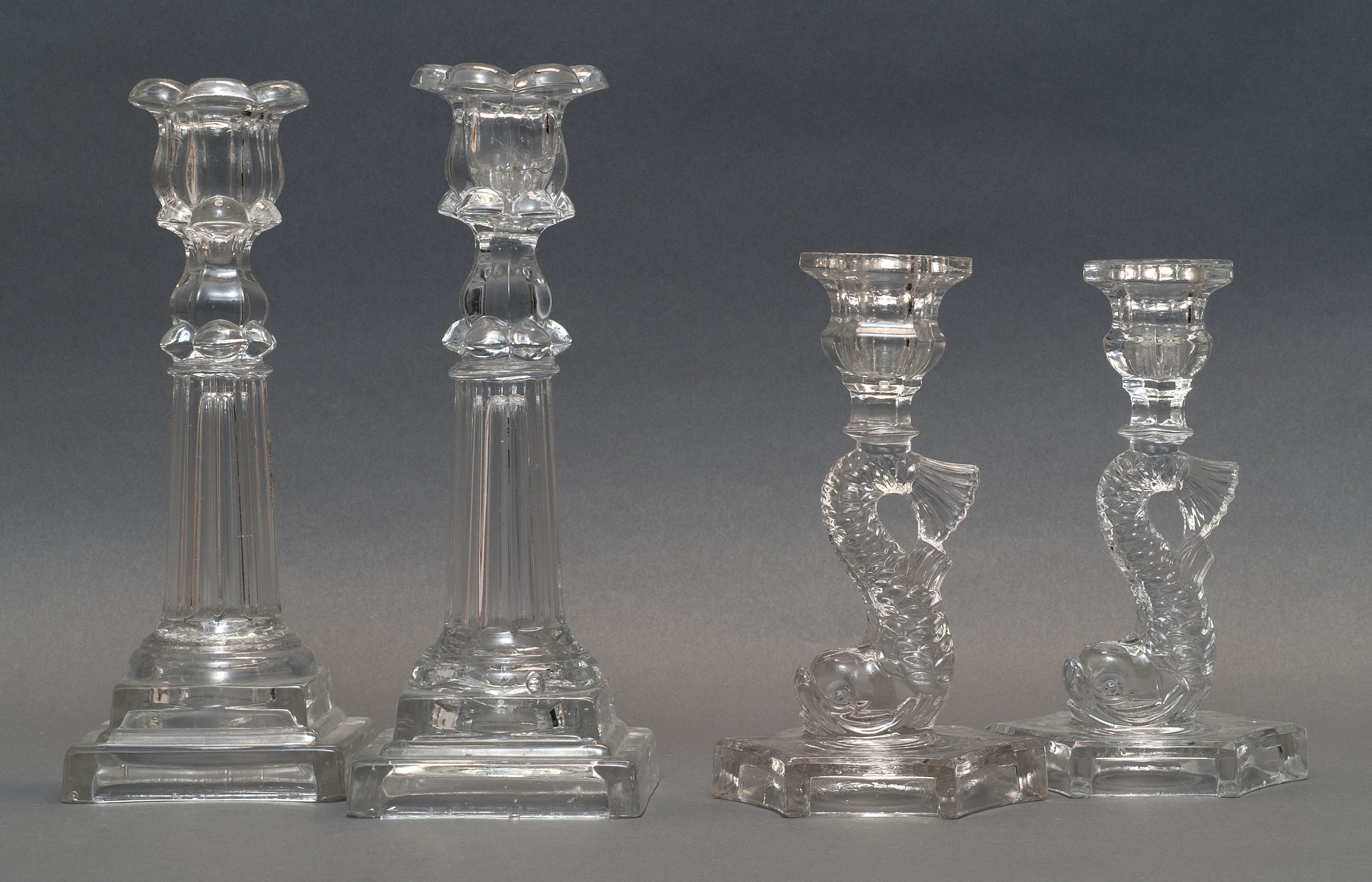 Appraisal: TWO PAIRS OF SANDWICH GLASS COMPANY CLEAR PRESSED GLASS CANDLESTICKS