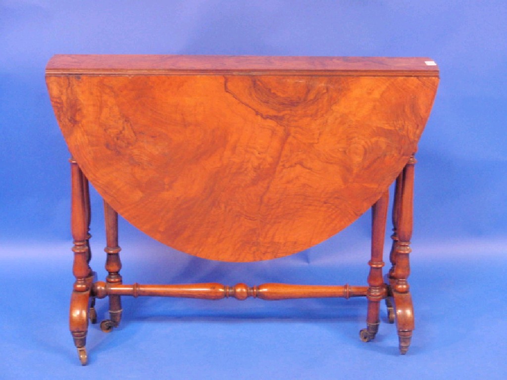 Appraisal: A Victorian figured walnut Sutherland table with oval folding top