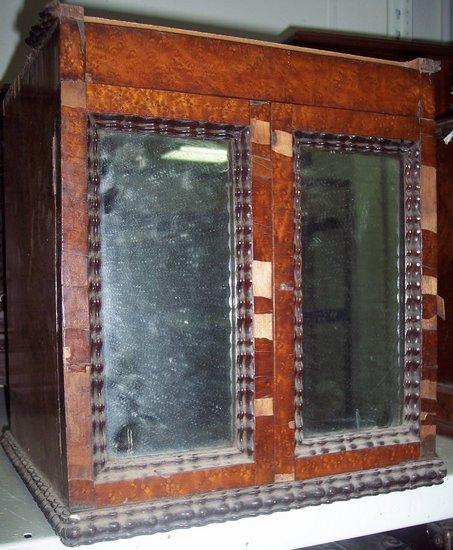 Appraisal: A Victorian coin cabinet with frieze drawer above two mirror