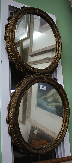 Appraisal: A PAIR OF OVAL GILT FRAMED WALL MIRRORS each cm