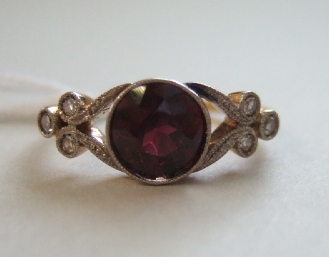 Appraisal: A diamond and garnet ring mounted with the circular cut