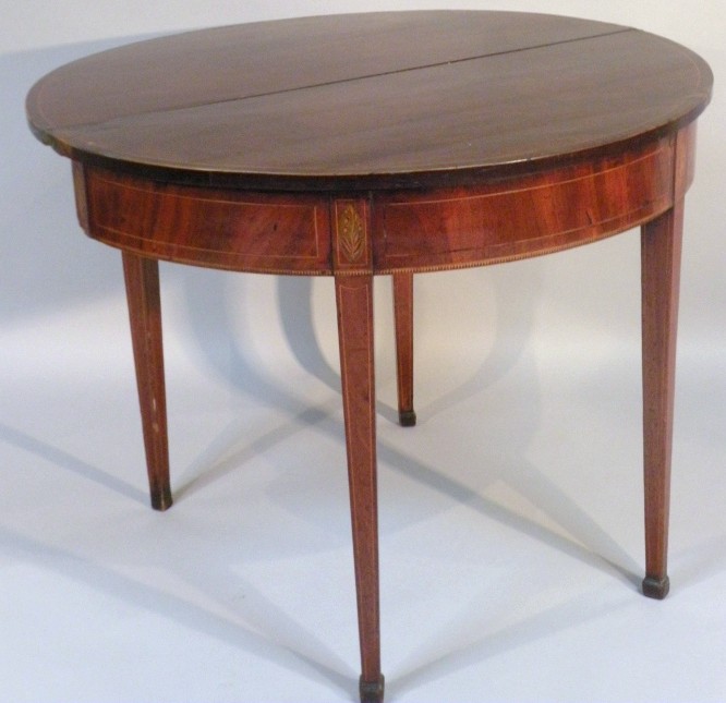 Appraisal: A thC mahogany demi-lune tea table the plain top with