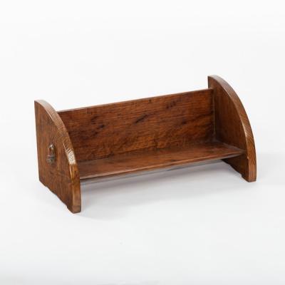 Appraisal: An Arts Crafts oak book trough with carved acorn to