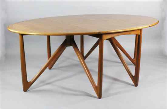 Appraisal: A 's Danish teak gateleg table with stylish hinges and