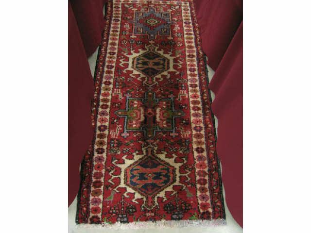 Appraisal: Heriz Persian Handmade Rug geometric medallions red field ' x