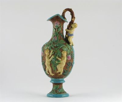 Appraisal: A Majolica ewer each side moulded with two cherubs amongst