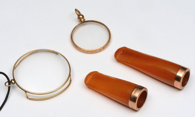 Appraisal: TWO AMBER CIGAR HOLDERS with ct gold mounts together with