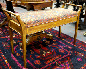 Appraisal: An Edwardian satinwood and mahogany music seat the rectangular upholstered