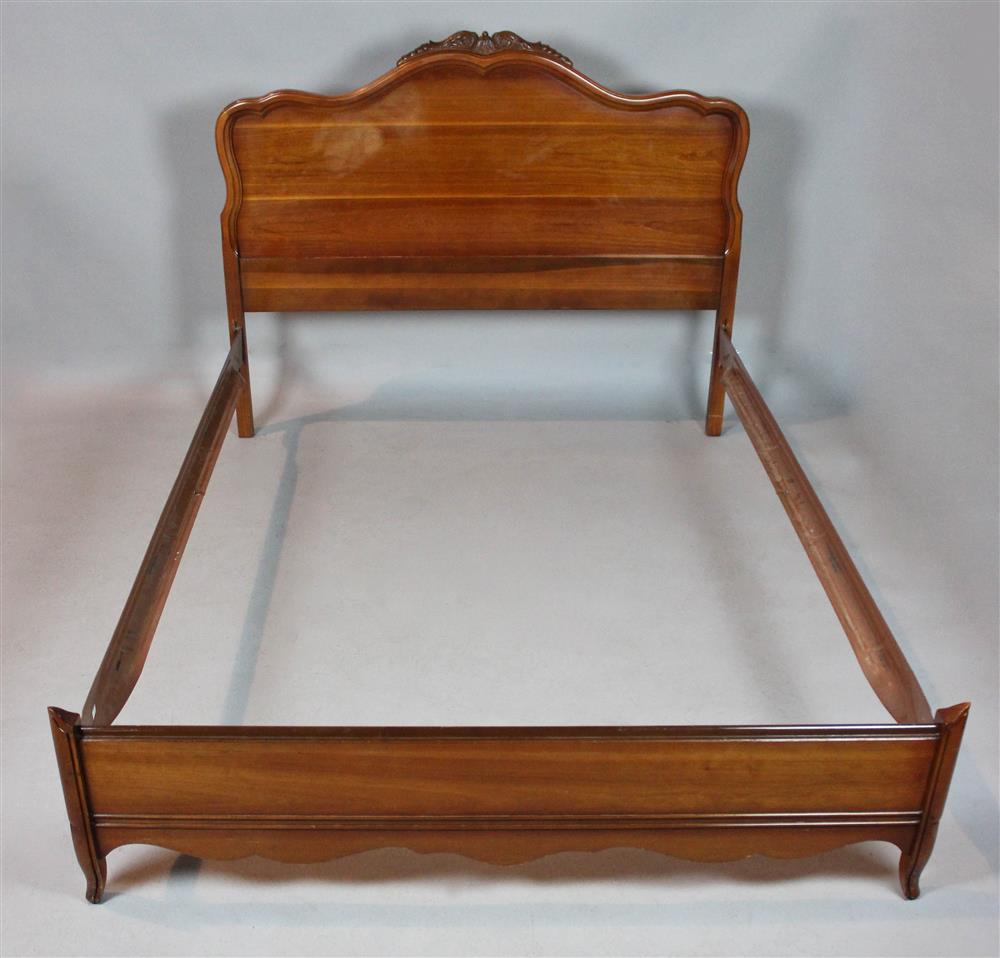 Appraisal: FRENCH PROVINCIAL STYLE FRUITWOOD BED having a shaped and molded