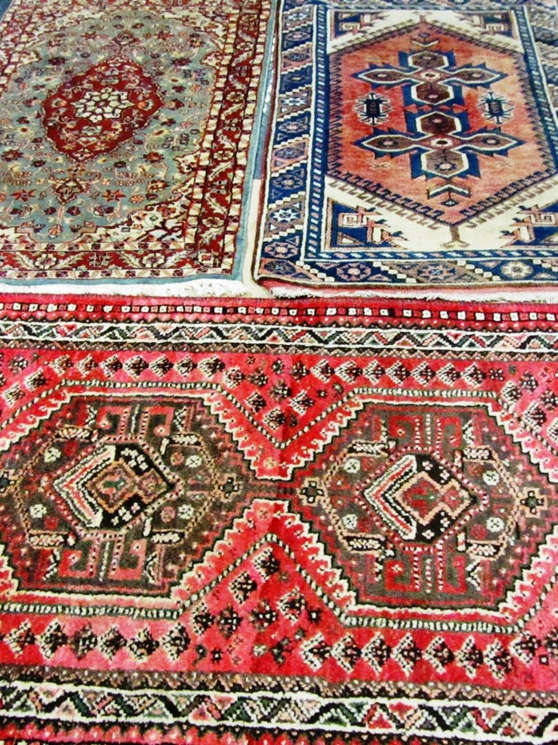 Appraisal: A Shiraz rug Persian the madder field with two medallions