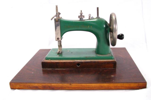 Appraisal: Canvas Craft Miniature Sewing Machine functional with tin body mounted