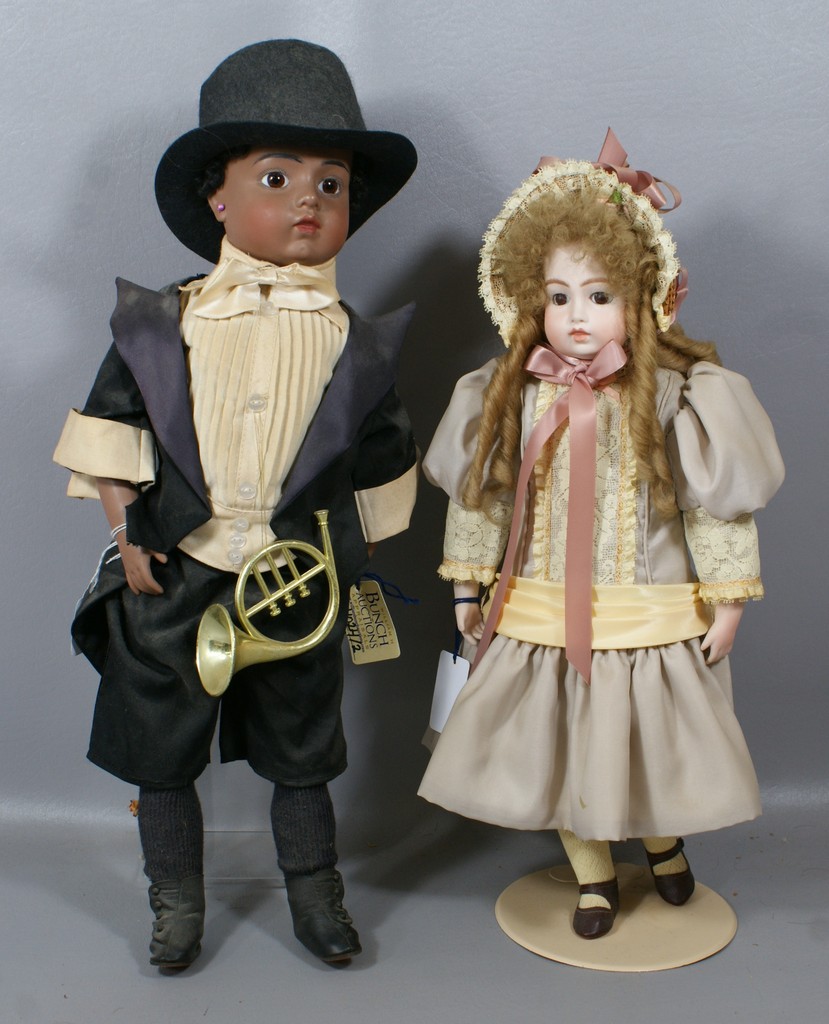 Appraisal: Reproduction Bru dolls larger is a brown bisque boy with