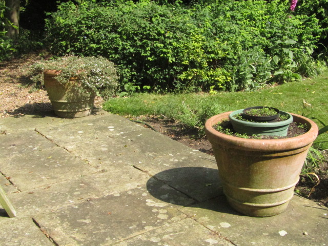 Appraisal: A set of four terracotta garden planters of circular tapering