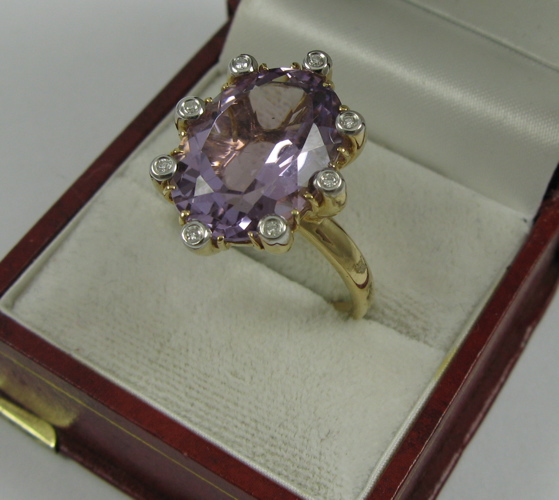 Appraisal: AMETHYST DIAMOND AND K GOLD RING eight round-cut diamonds surround