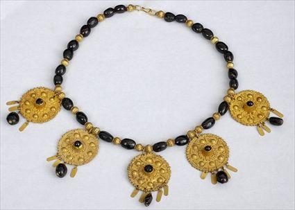 Appraisal: EARLY PERSIAN GRANULATED GOLD DISK PENDANTS ON GARNET AND GOLD