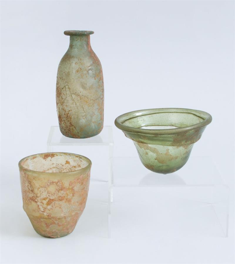 Appraisal: THREE ROMAN GLASS VESSELS Comprising a belted beaker a green