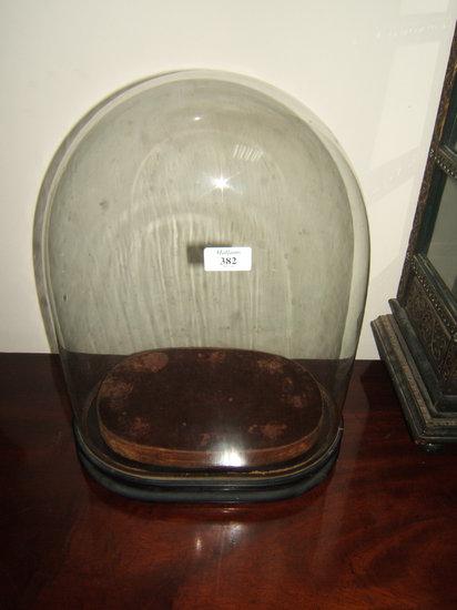 Appraisal: A Victorian glass dome standing on an ebonised oval base