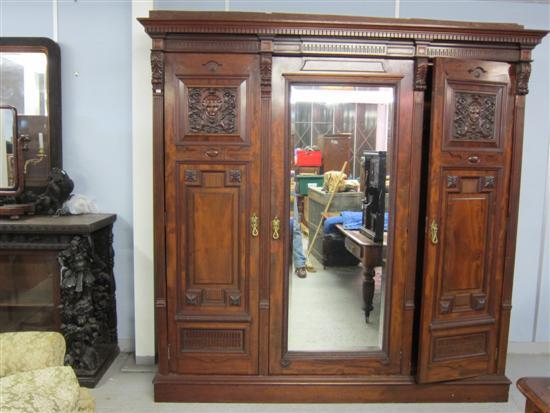 Appraisal: Late th century mahogany triple wardrobe with central mirror door