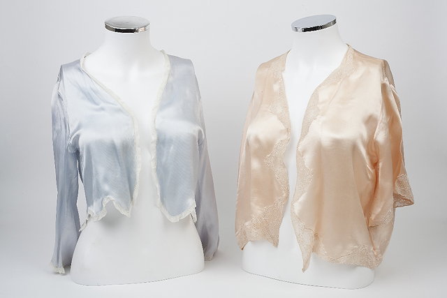 Appraisal: Two pastel coloured lace edged silk boleros each with length