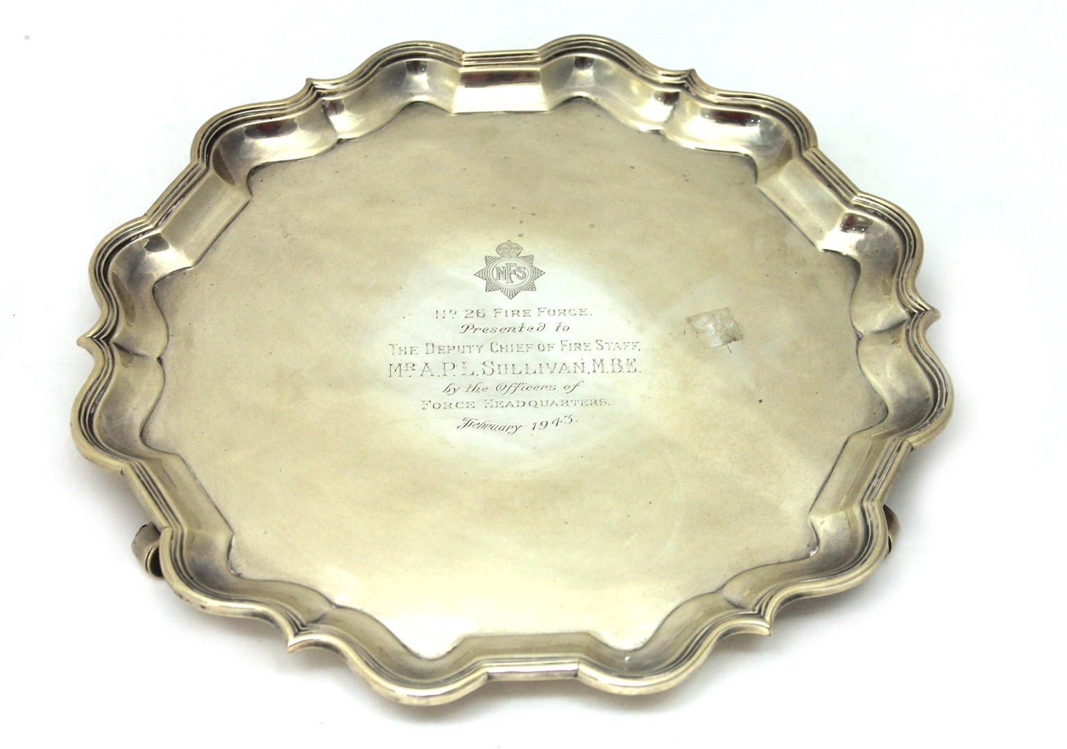 Appraisal: A silver shaped circular salver presentation inscribed and raised on