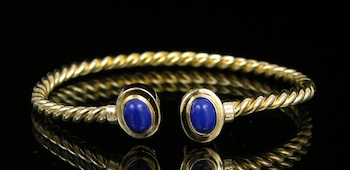 Appraisal: A Yellow Gold Bangle Bracelet set with Lapis Twisted design