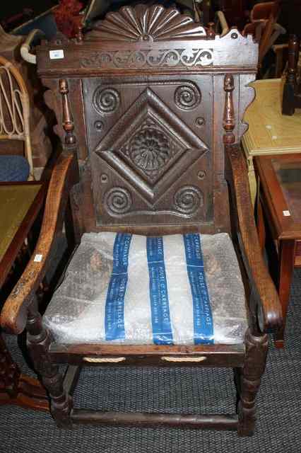 Appraisal: AN ANTIQUE OAK WAINSCOT CHAIR with fan carved cresting rail