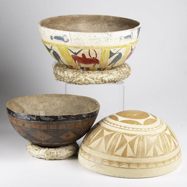 Appraisal: THREE DECORATED AFRICAN CALABASH A collection of gourd bowls with