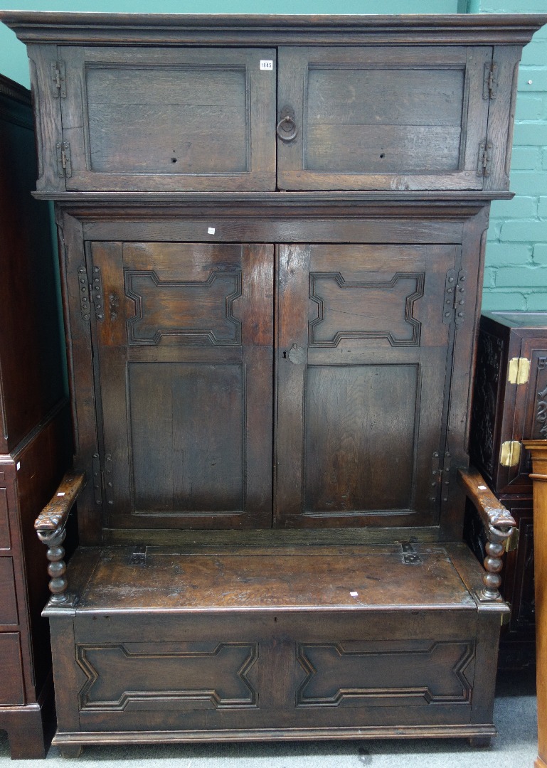 Appraisal: A th century and later made-up oak bacon cupboard settle