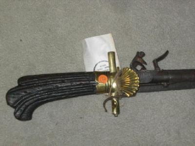 Appraisal: A HUNTING SWORD-PISTOL with shell langet simple brass guard carved