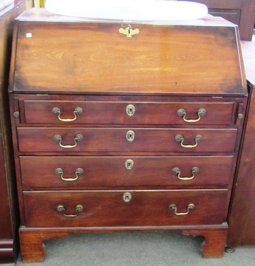 Appraisal: A George III mahogany bureau the fall enclosing a fitted