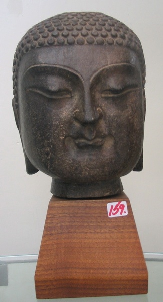 Appraisal: STONE SCULPTURE head of Gautama Buddha in tall raised on