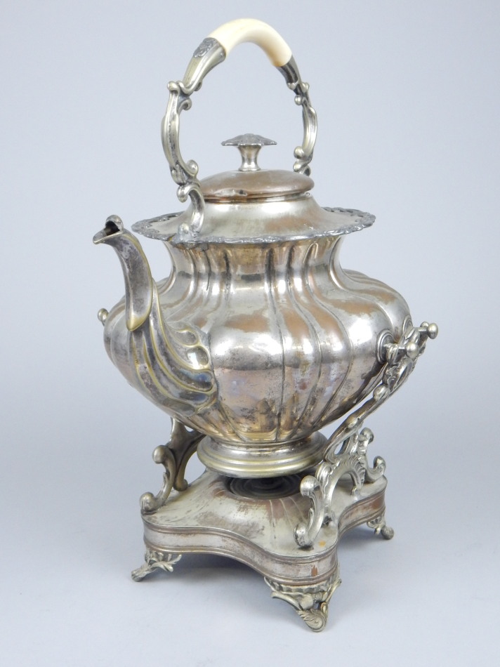 Appraisal: A thC silver plated tea kettle and stand with an