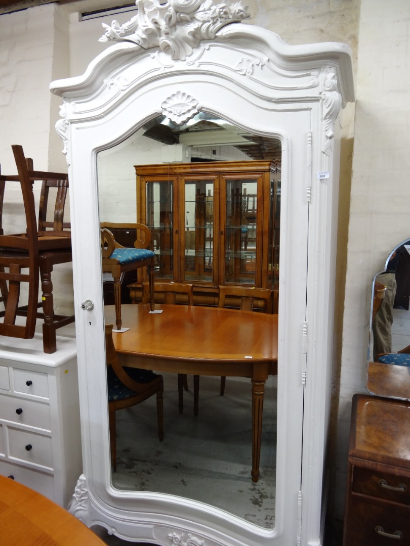 Appraisal: A French armoire wardrobe with heavily carved fixed cornice and