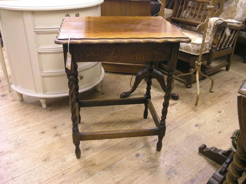 Appraisal: A solid dark oak occasional table rectangular top on barley-twist