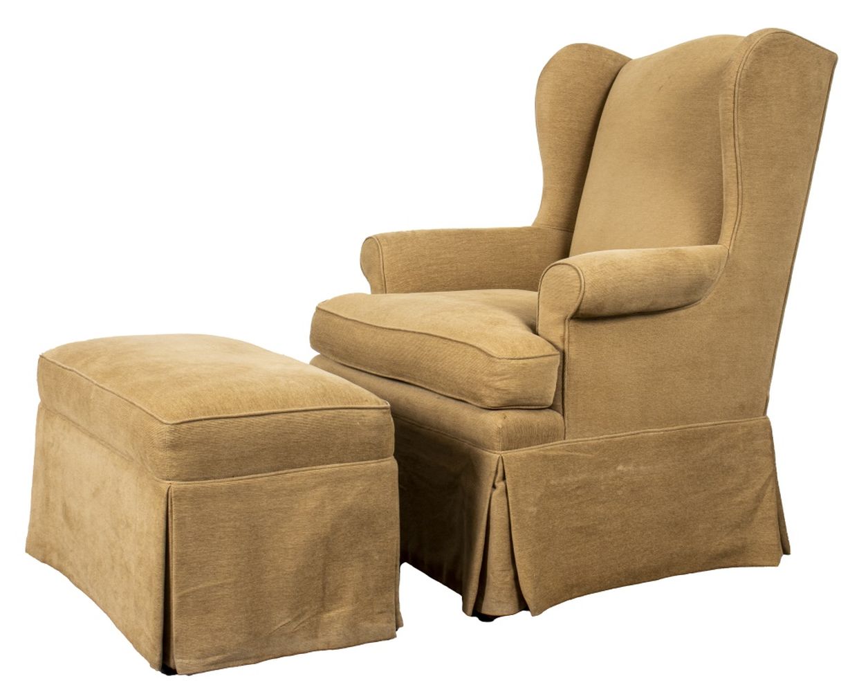 Appraisal: UPHOLSTERED WINGCHAIR AND OTTOMAN A beige cotton velvet upholstered skirted