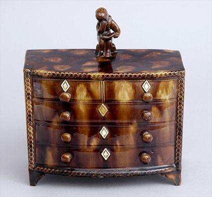 Appraisal: ROCKINGHAM TORTOISHELL GLAZED POTTERY MINIATURE CHEST OF DRAWERS Of bow-front