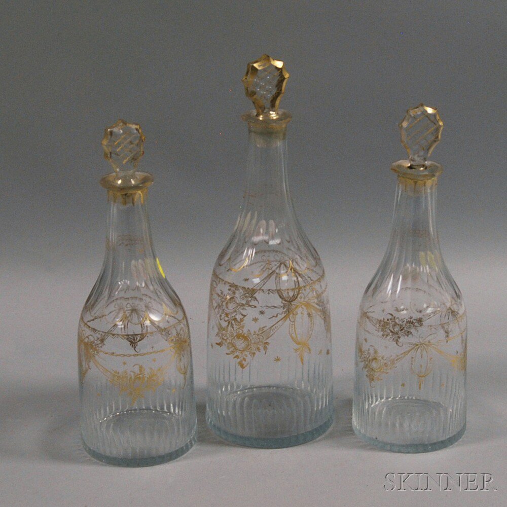 Appraisal: Three Gilt and Molded Glass Decanters th century a pair