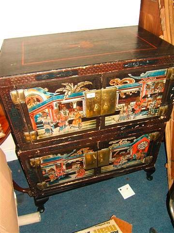 Appraisal: A pair of lacquered Oriental cabinets each with doors decorated