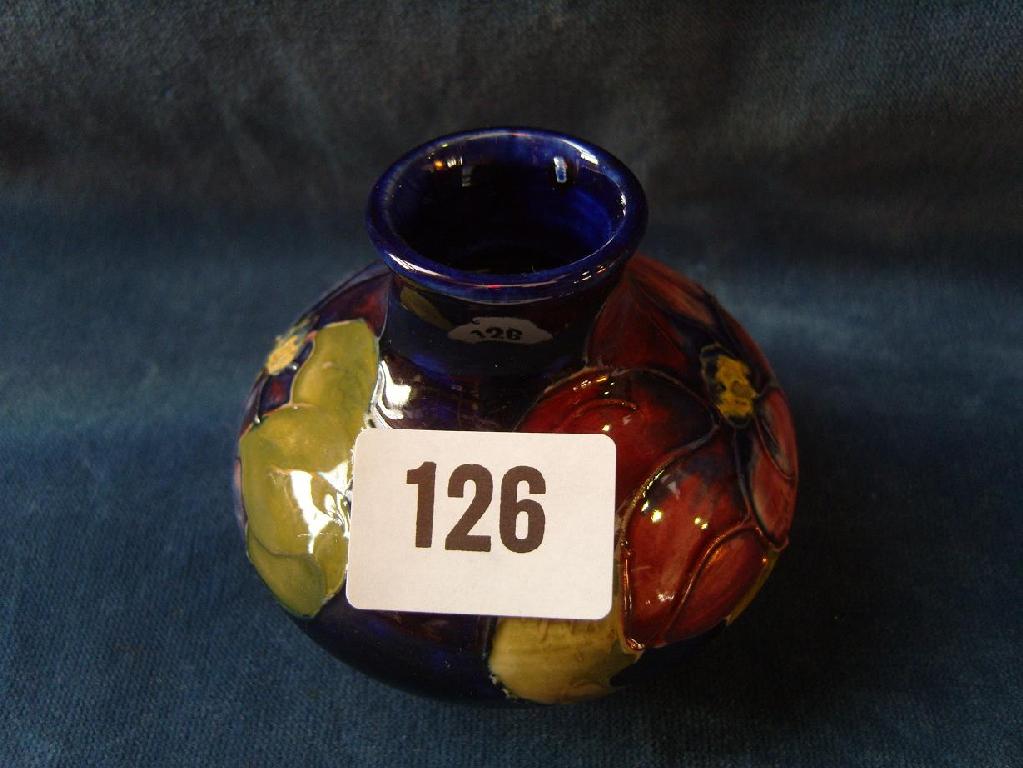 Appraisal: A small blue ground Moorcroft vase of flattened form with